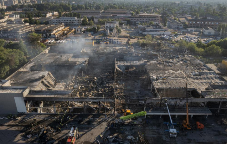 FILE - Ukrainian State Emergency Service firefighters work to take away debris at a shopping center burned after a rocket attack in Kremenchuk, Ukraine, Tuesday, June 28, 2022. AP/RSS Photo