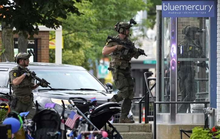 Law enforcement conduct a search after a mass shooting at the Highland Park Fourth of July parade in downtown Highland Park, Ill., a Chicago suburb on Monday, July 4, 2022. AP/RSS Photo