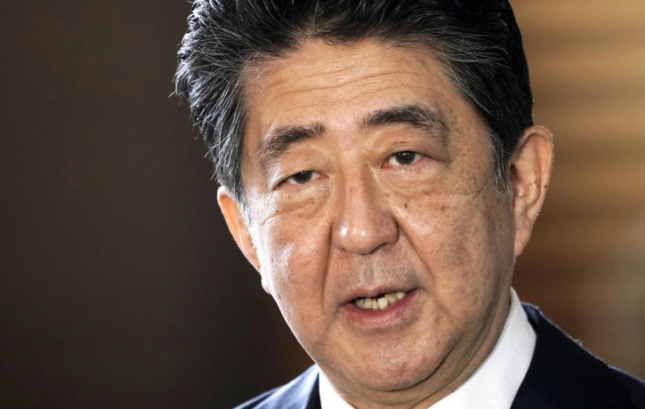 FILE - Japan's outgoing Prime Minister Shinzo Abe speaks to the media as he arrives at the prime minister's office for a cabinet meeting in Tokyo on Sept 16, 2020. (AP Photo/RSS)