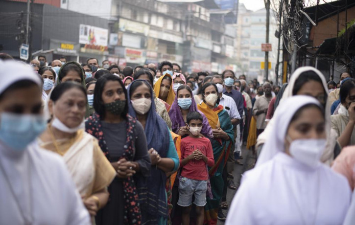 FILE - Indian Christians wearing masks as a precaution against COVID-19 gather for prayers as they observe Palm Sunday in Kochi, Kerala state, India, April 10, 2022.  AP/RSS Photo