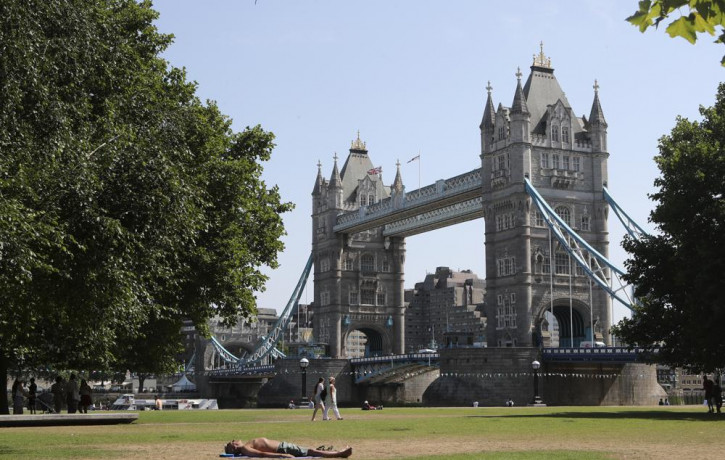 A man sunbathes backdropped by Tower Bridge in London, Tuesday July 19, 2022.  AP/RSS Photo