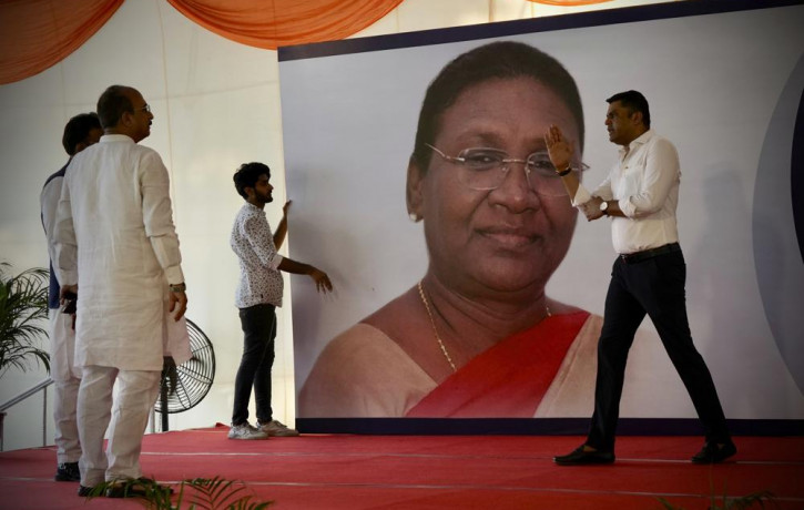 Workers put up a giant hoarding of Draupadi Murmu for her felicitation, before she was announced as the country's new President, in New Delhi, India, Thursday, July 21, 2022.  AP/RSS Photo