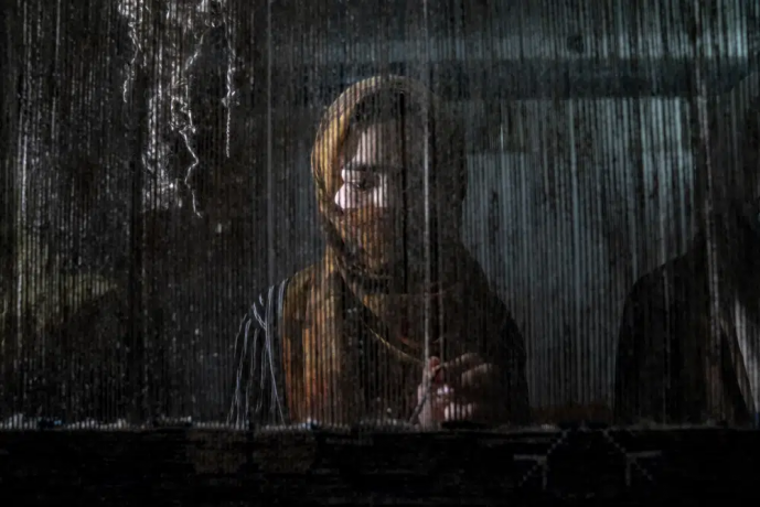 An Afghan woman weaves a carpet at a traditional carpet factory in Kabul, Afghanistan, Monday, March 6, 2023. After the Taliban came to power in Afghanistan, women have been deprived of many of their basic rights. AP/RSS Photo