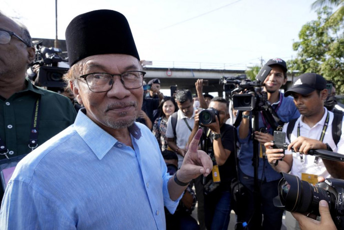 FILE - Opposition leader Anwar Ibrahim shows his inked finger to the media after voting at a polling station in Seberang Perai, Penang state, Malaysia on Nov. 19, 2022. AP/RSS Photo
