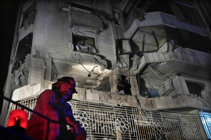 A firefighter stands in front of an apartment hit by an Israeli airstrike, in Beirut, Lebanon, Thursday, Oct. 3, 2024. (AP Photo)