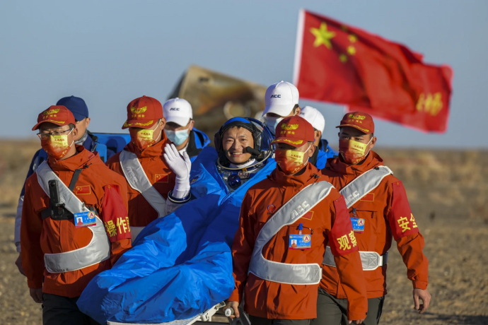 In this photo released by Xinhua News Agency, astronaut Gui Haichao waves as he is carried out of the re-entry capsule of the Shenzhou-14 manned space mission after it landed successfully at the Dongfeng landing site in northern China’s Inner Mongolia Autonomous Region, Tuesday, Oct. 31, 2023.