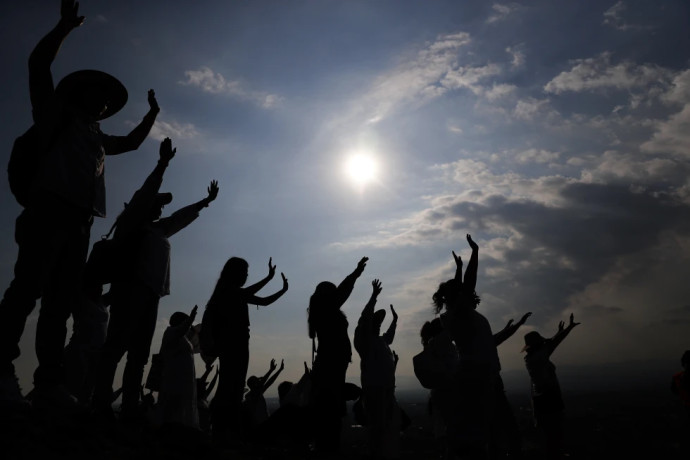 FILE - Visitors hold their hands out to receive the sun’s energy as they celebrate the Spring equinox atop the Pyramid of the Sun in Teotihuacan, Mexico, Thursday, March 21, 2019. Spring gets its official start Tuesday, March 19, 2024, in the Northern Hemisphere. On the equinoxes, the Earth’s axis and orbit line up so both hemispheres get the same amount of sunlight. AP/RSS Photo