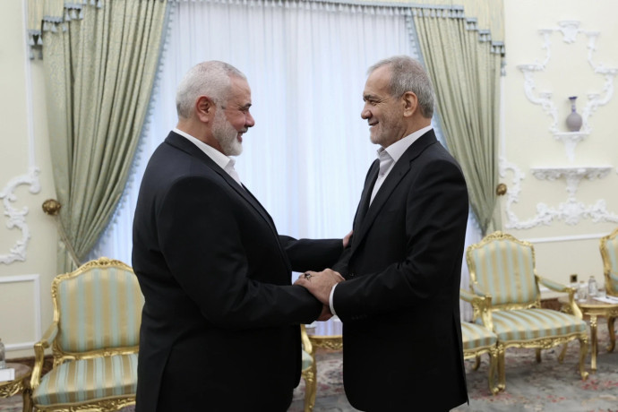 Haniyeh (l) with Iranian President Masoud Pezeshkian. AP/RSS Photo