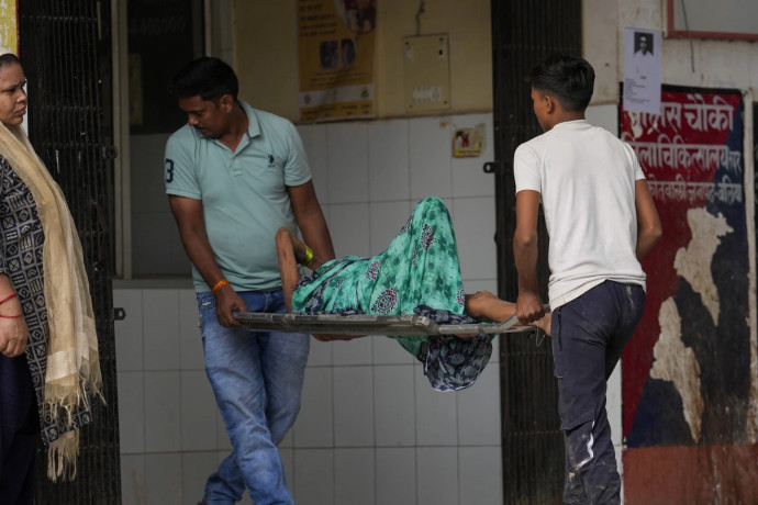 FILE - An elderly woman suffering from heat related ailment is brought to an overcrowded government district hospital in Ballia, Uttar Pradesh state, India, June 20, 2023. As temperatures and humidity soar outside, what's happening inside the human body can become a life-or-death battle decided by just a few degrees. AP/RSS Photo