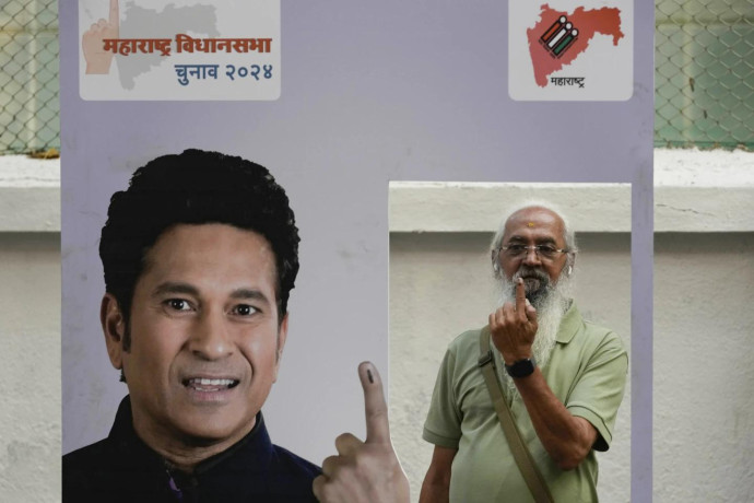 Senior citizen Amol Prabhu shows his index finger after casting his vote during Maharashtra state assembly elections in Mumbai, India, Wednesday, Nov 20, 2024. (AP Photo)