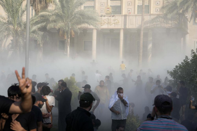 Iraqi security forces fire tear gas on followers of Shiite cleric Muqtada al-Sadr protesting inside the government palace grounds, in Baghdad, Iraq, Monday, Aug. 29, 2022. AP/RSS Photo