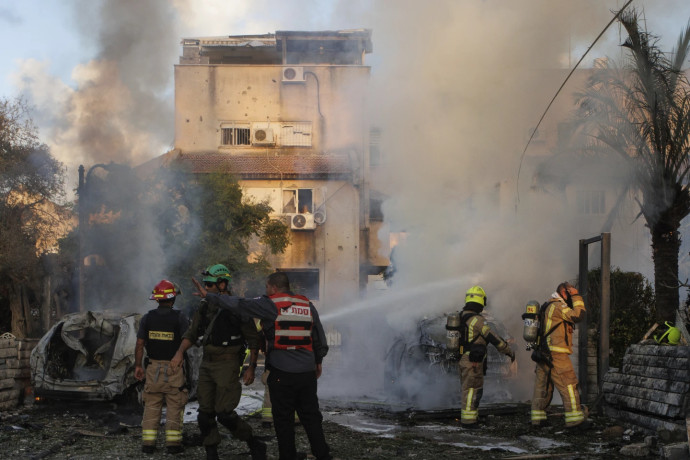 Israeli security forces work at the site hit by a rocket fired from Lebanon, in Kiryat Bialik, northern Israel, on Sunday, Sept. 22, 2024. APRSS Photo