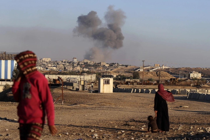 Smoke rises following an Israeli airstrike on buildings near the separating wall between Egypt and Rafah, southern Gaza Strip, Tuesday, May 7, 2024. (AP Photo)