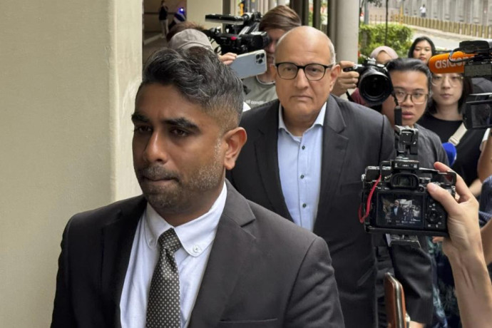 Former Transport Minister S. Iswaran, center, and his lawyer Navin Thevar arrive at the High Court in Singapore, July 5, 2024. (AP Photo)