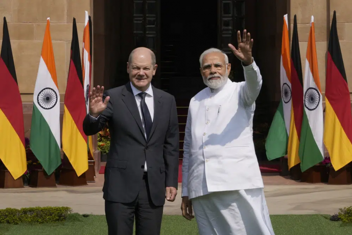 Indian Prime Minister Narendra Modi, right, with German Chancellor Olaf Scholz, wave to media before their meeting in New Delhi, India, Saturday, Feb. 25, 2023. AP/RSS Photo