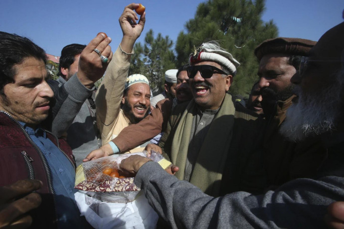 Malik Tariq Awan, center right, an independent candidate, celebrates with supporters after his victory in the parliamentary elections, in Peshawar, Pakistan, Friday, Feb. 9, 2024. (AP/RSS Photo)