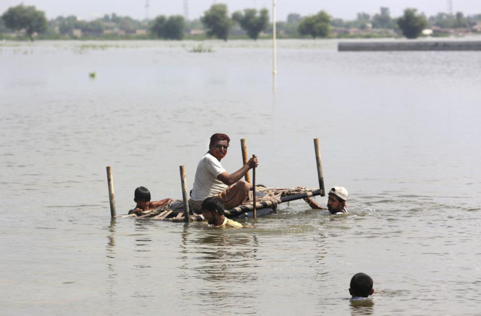 People use cot to salvage belongings from their nearby flooded home caused by heavy rain in Jaffarabad, a district of Pakistan's southwestern Baluchistan province, Saturday, Sep. 3, 2022. AP/RSS Photo