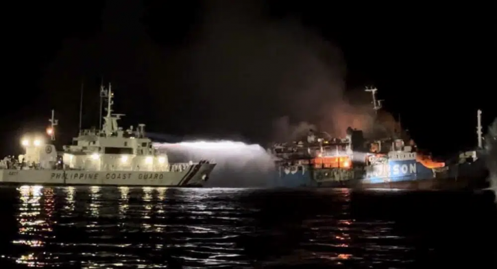 In this photo provided by the Philippine Coast Guard, a Philippine Coast Guard ship trains its hose as it tries to extinguish fire on the MV Lady Mary Joy at Basilan, southern Philippines early Thursday March 30, 2023.  AP/RSS Photo