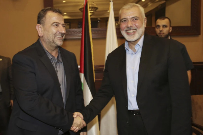 FILE - In this photo released by the Hamas Media Office, Ismail Haniyeh, right, the head of the Hamas political bureau, shakes hands with his deputy Saleh Arouri upon his arrival in Gaza from Cairo, Egypt, in Gaza City, Thursday, Aug. 2, 2018. (AP/RSS Photo)
