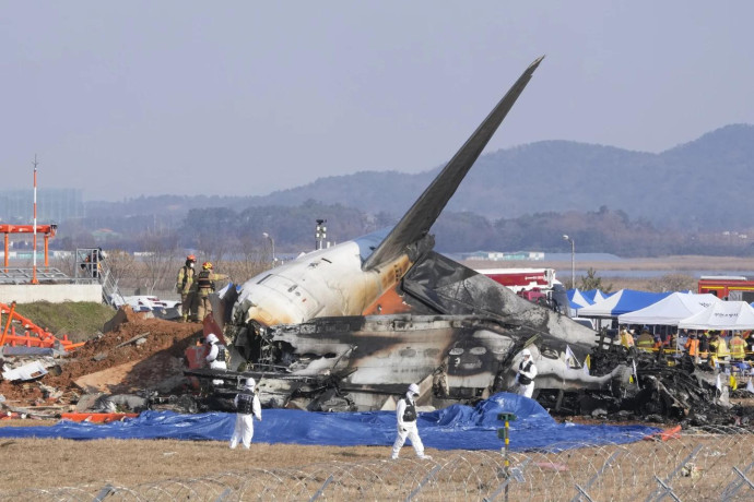 Firefighters and rescue team members work near the wreckage of a passenger plane at Muan International Airport in Muan, South Korea, Sunday, Dec. 29, 2024. (AP Photo)