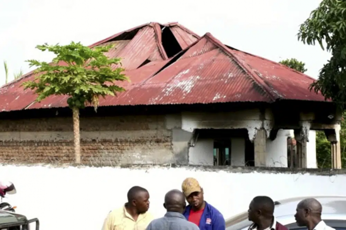 In this image made from video, people gather in front of a building of the Lhubiriha Secondary School following an attack on the school near the border with Congo, in Mpondwe, Uganda, Saturday, June 17, 2023.  AP/RSS Photo