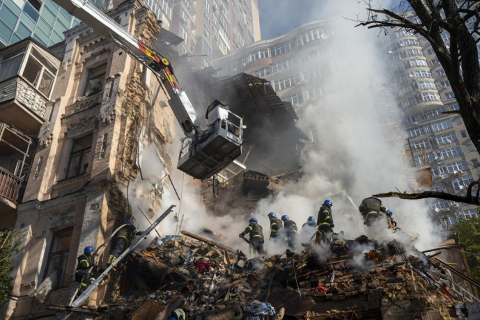 FILE - Firefighters work after a drone attack on buildings in Kyiv, Ukraine, on Oct 17, 2022. (AP/RSS Photo)