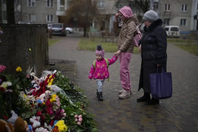 People pay their respects at the scene where a helicopter crashed into civil infrastructure on Wednesday, in Brovary, on the outskirts of Kyiv, Ukraine, Friday, Jan. 20, 2023 AP/RSS Photo