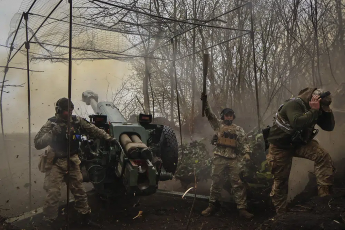 FILE - Ukrainian soldiers fire a howitzer D-30 at the frontline near Bakhmut, Donetsk region, Ukraine, Wednesday, April 19, 2023. AP/RSS Photo