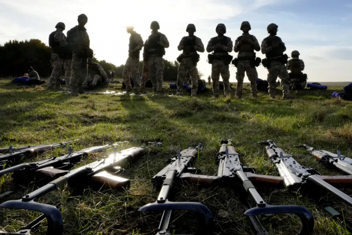 FILE - Weapons lie on the ground as Ukrainian personnel take a break during training at a military base with UK Armed Forces in Southern England on Oct. 12, 2022.  AP/RSS Photo