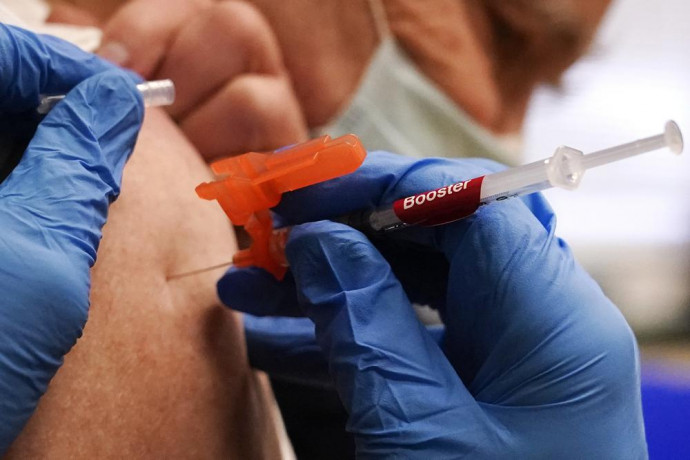 FILE - A pharmacist injects a patient with a booster dosage of the Moderna COVID-19 vaccine at a vaccination clinic in Lawrence, Massachusetts, on Wednesday, Dec. 29, 2021. AP/RSS Photo