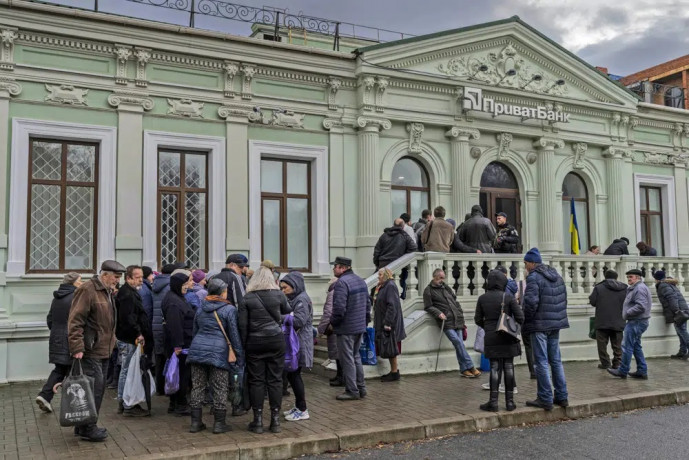 FILE - Residents queue at a bank branch in Kherson, southern Ukraine, Nov. 21, 2022. AP/RSS Photo