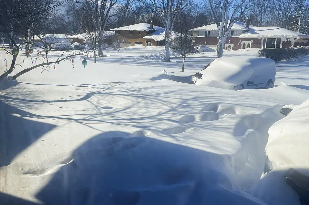 A car sits blanketed in snow on a driveway, Sunday, Dec. 25, 2022, in Amherst, New York. AP/RSS Photo