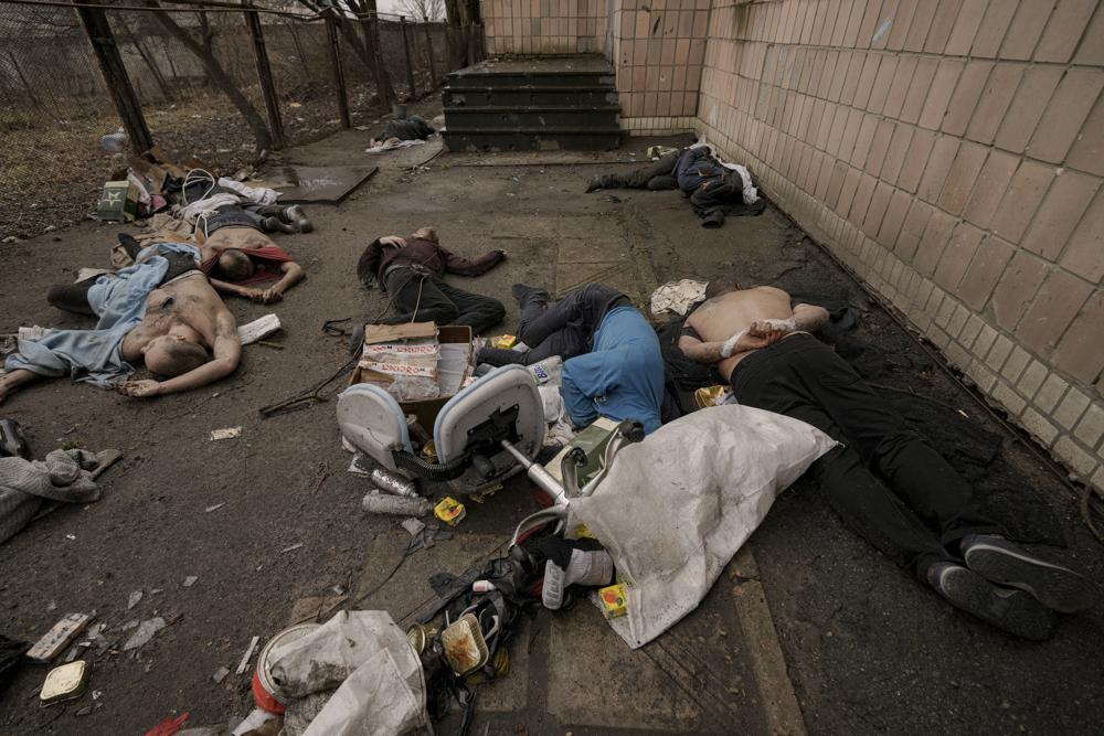 EDS NOTE: GRAPHIC CONTENT - FILE - Lifeless bodies of men, some with their hands tied behind their backs, lie on the ground in Bucha, Ukraine, Sunday, April 3, 2022. Russian soldiers picked up these men on March 4, 2022, as they swept the streets of Bucha to identify and neutralize potential threats. AP/RSS Photo