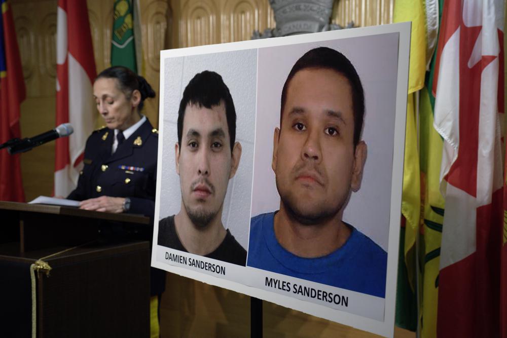 Assistant Commissioner Rhonda Blackmore speaks next to images of Damien Sanderson and Myles Sanderson during a press conference at the Royal Canadian Mounted Police "F" Division headquarters in Regina, Saskatchewan, on Sunday. AP/RSS Photo