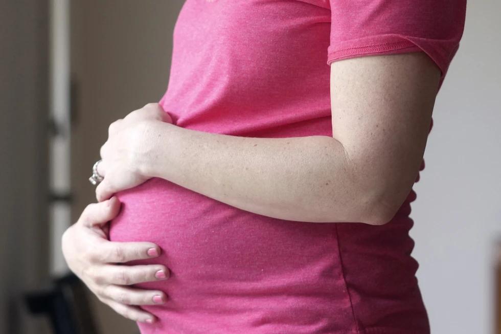 FILE - A pregnant woman stands for a portrait in Dallas, Thursday, May 18, 2023.  AP/RSS Photo