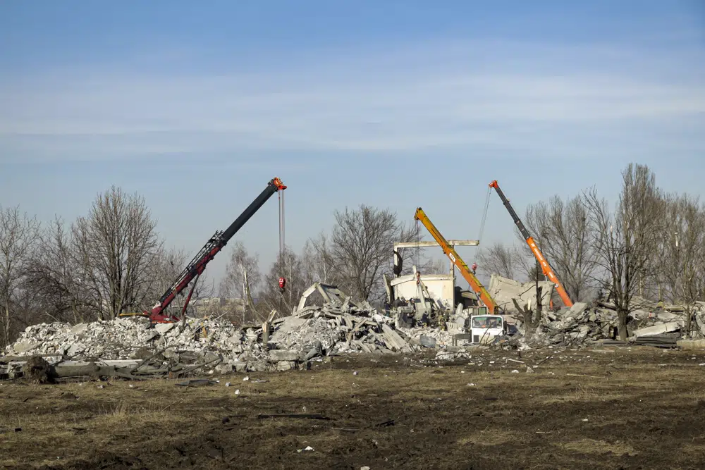 Workers clean rubbles after Ukrainian rocket strike in Makiivka, in Russian-controlled Donetsk region, eastern Ukraine, Tuesday, Jan. 3, 2023. AP/RSS Photo