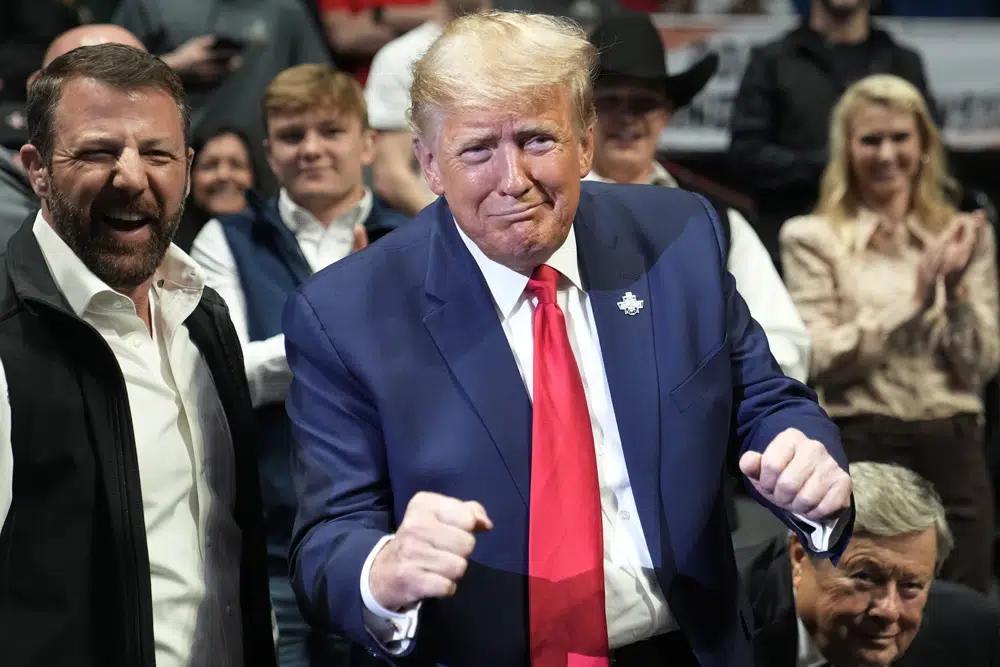 Former US President Donald J. Trump gestures to Vito Arujau, NCAA wrestling champion at the 133 lb class, at the NCAA Wrestling Championships, Saturday, March 18, 2023, in Tulsa, Okla. At left if U.S. Senator Markwayne Mullin. AP/RSS Photo