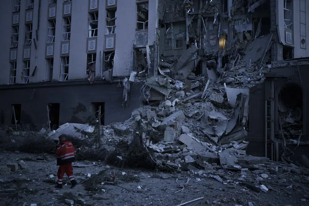 An emergency worker walks in front of a damaged hotel following a Russian attack in Kyiv, Ukraine, Saturday, Dec. 31, 2022. AP/RSS Photo