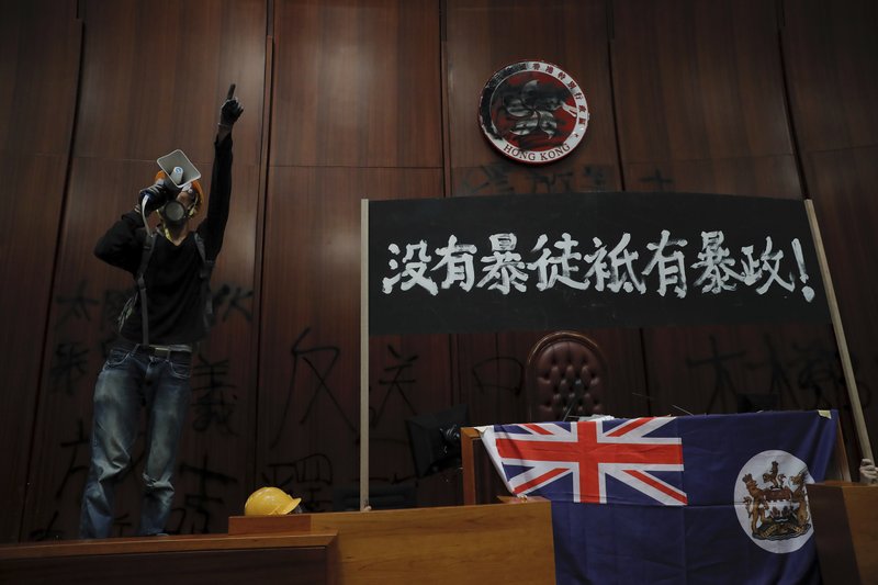Protesters storm Hong Kong’s legislature, deface portraits of lawmakers and spray-paint pro-democracy slogans